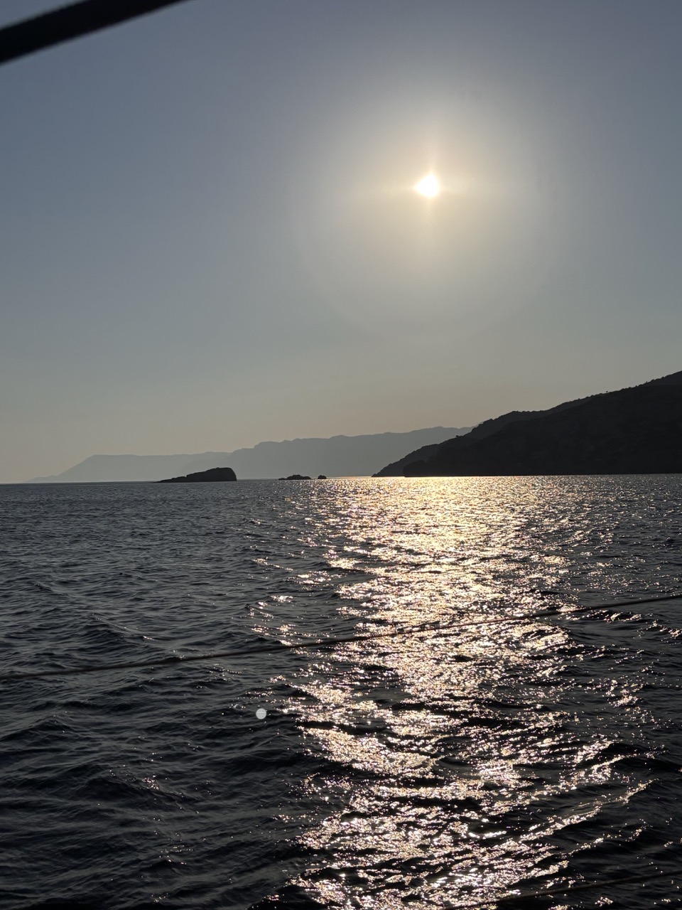 Hazy evening light over the Icarian Sea, headlands fading into the distance