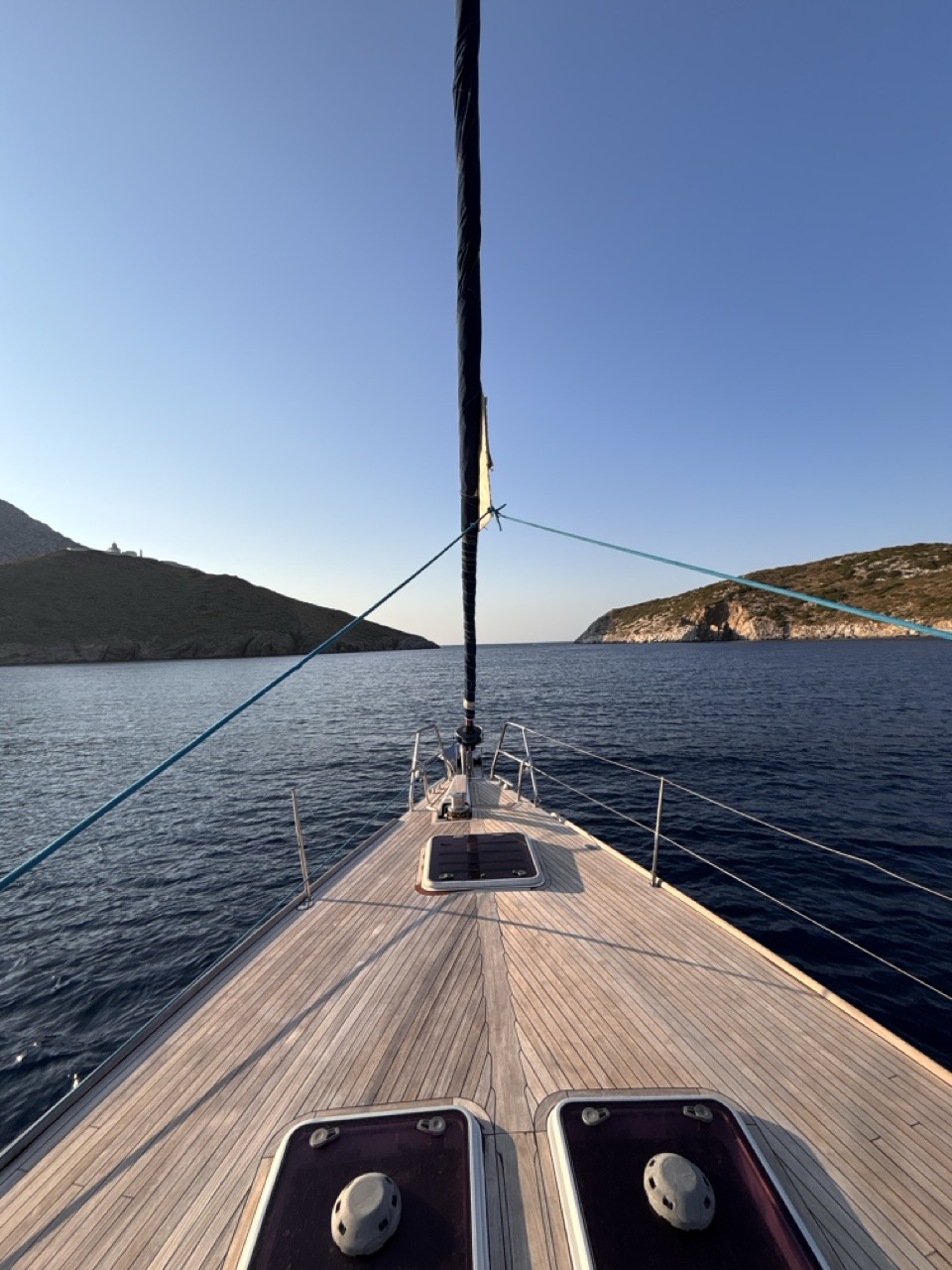 Looking over the bow at anchor, between the bare hills of Fournoi